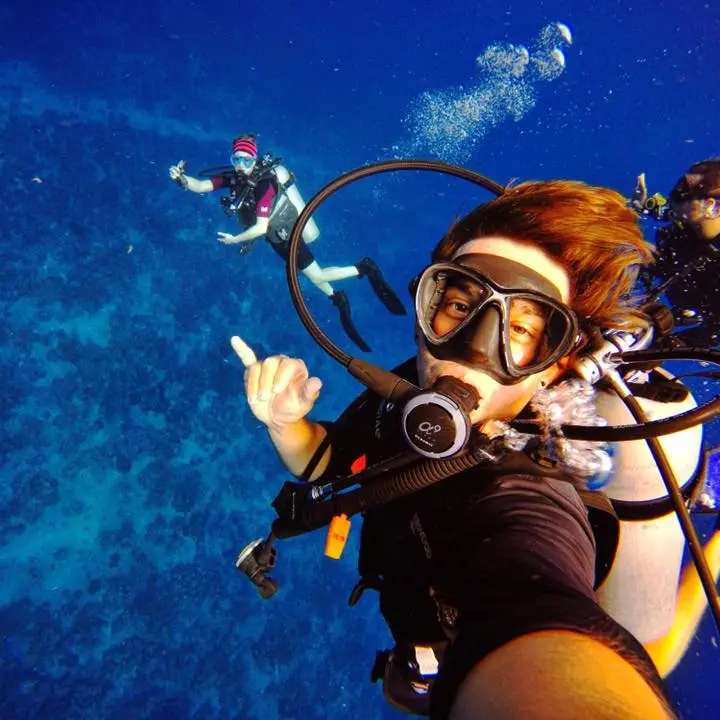 A group of friends taking a selfie while underwater