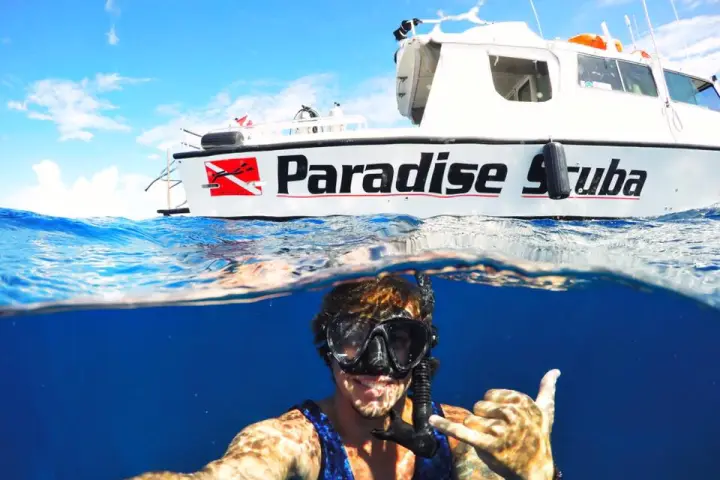 A diver taking a selfie with one of the vessels